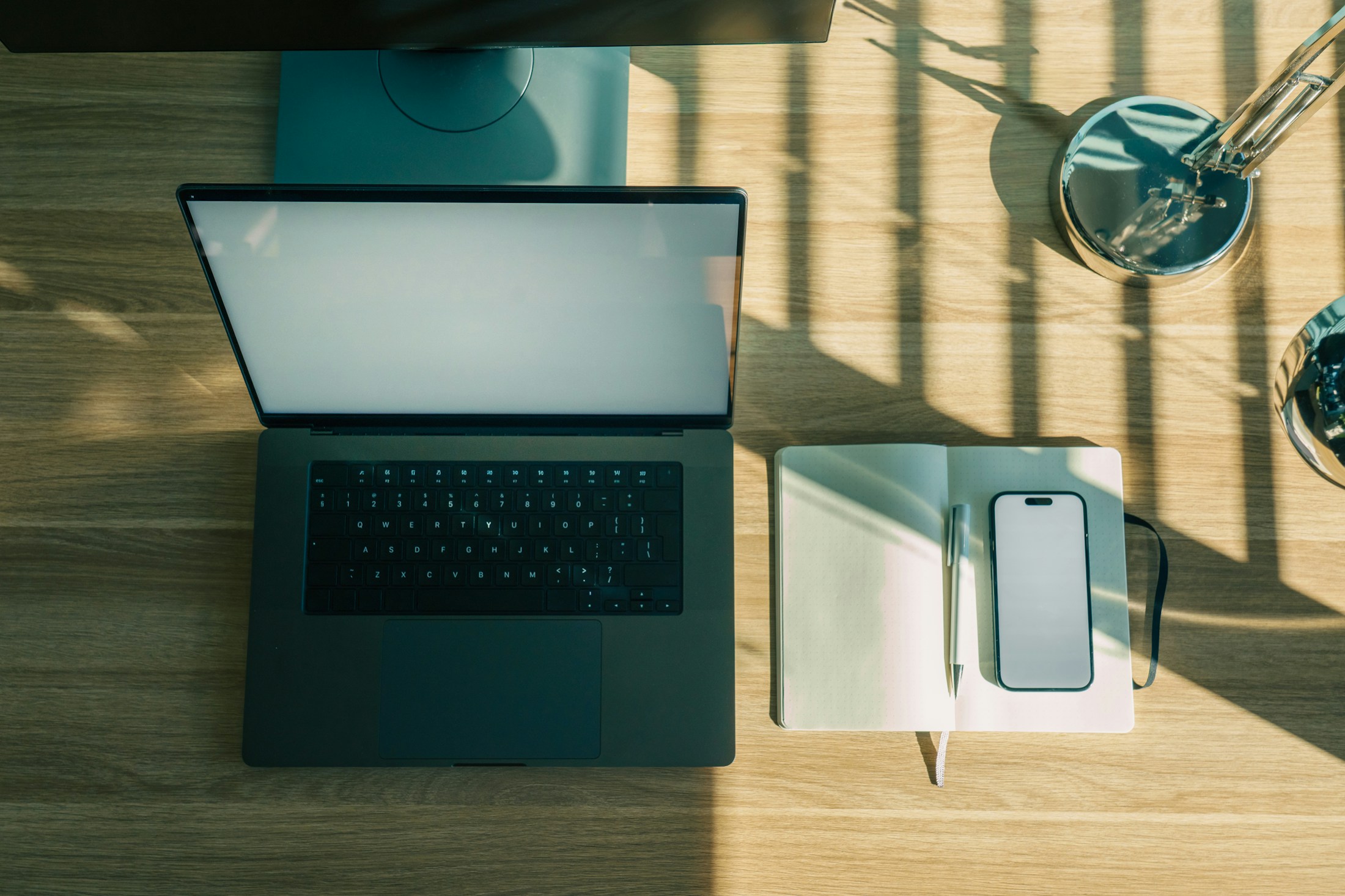 A calm workspace with a laptop and notebook